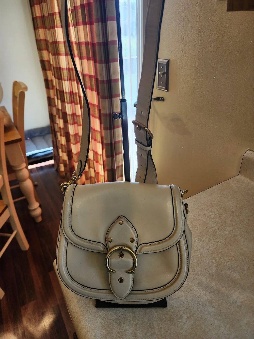 2021 Ivory Coach Beat saddle bag is crafted from glovetanned leather and brass